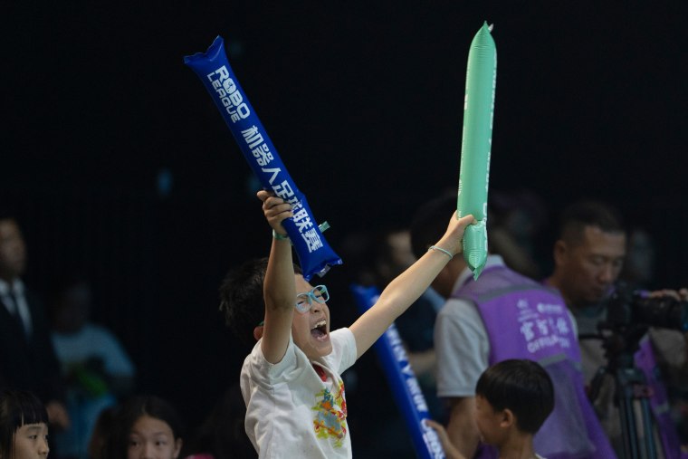 A fan cheering on the robot athletes in Beijing on Saturday.