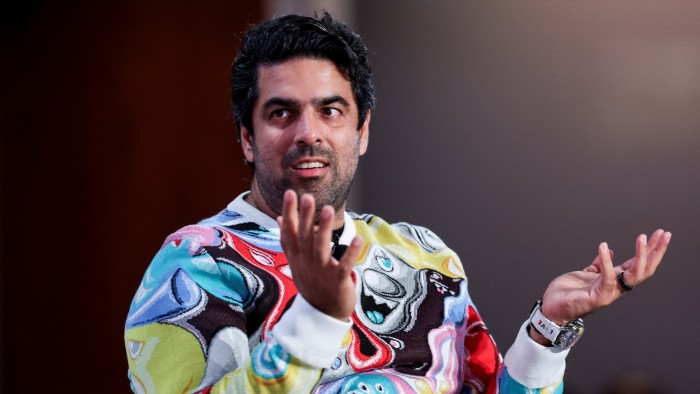 Sachin Dev Duggal raises his hands in a gesture as he speaks