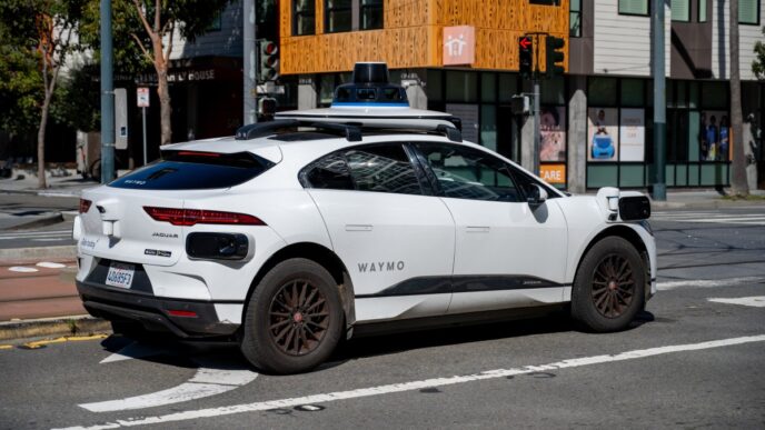 Waymo self driving car waiting at a city intersection in San Francisco