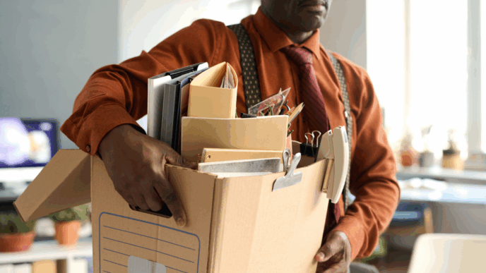 Man leaves work with box