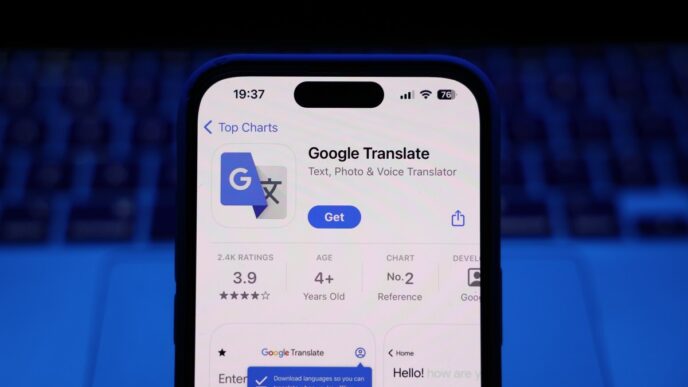 A laptop keyboard and Google Translate on App Store displayed on a phone screen are seen in this illustration photo
