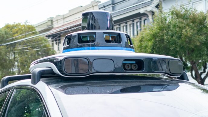 A Waymo self-driving car is seen in the Inner Richmond neighborhood of San Francisco, California, with the Lidar unit on the vehicle visible, November 17, 2024.