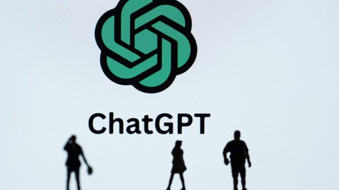This photograph taken in Mulhouse, eastern France on October 19, 2023, shows figurines next to the ChatGPT logo. (Photo by SEBASTIEN BOZON/AFP via Getty Images)