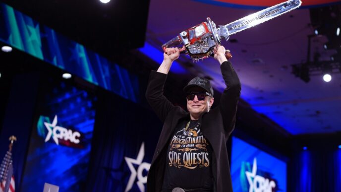 CEO of Tesla and SpaceX Elon Musk holding a chainsaw above his head.