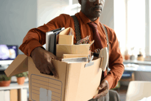 Man leaves work with box