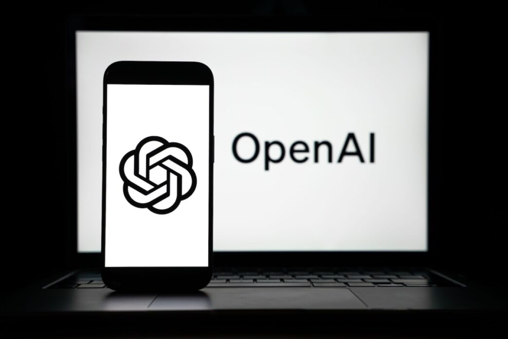 the logos of Open AI displayed on both computer and smart phone screen