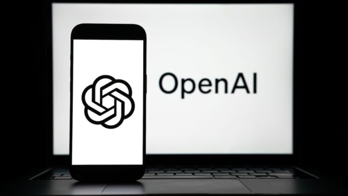 the logos of Open AI displayed on both computer and smart phone screen