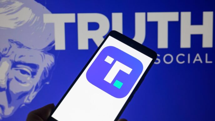 The Truth Social app icon is being displayed on a smartphone with Truth Social visible in the background in this photo illustration.
